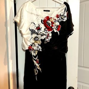 Silk dress falls above the knee.